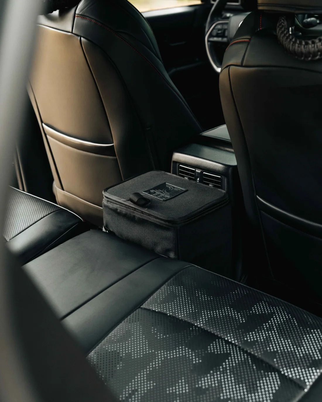 Wide view of the Double Deez Goodz car trash bin in the rear passenger area of a vehicle.