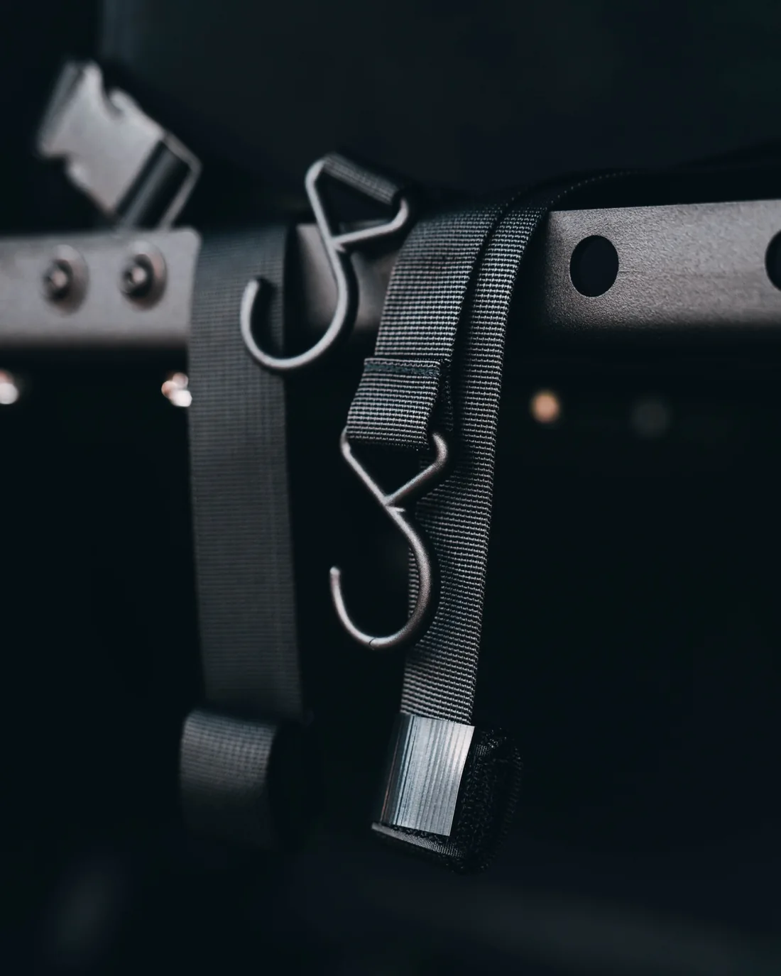 Macro detail of the Double Deez Goodz car trash can hanging hooks and woven mounting straps.